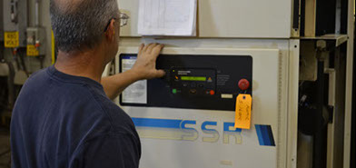 Service Technician running diagnostics on an Air Compressor.